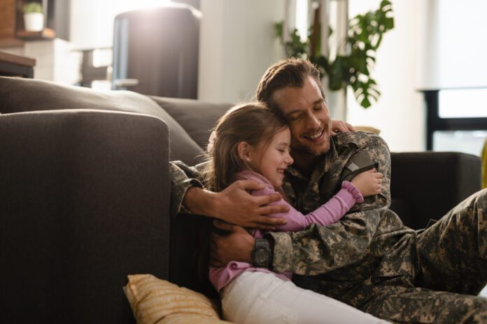 Father hugging his daughter on the sofa, creating a warm, loving moment in a cozy living room.